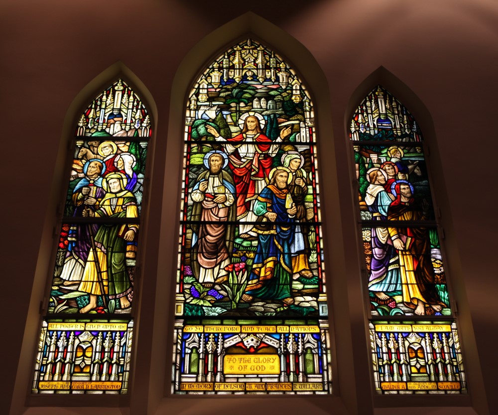 Three stained glass windows in a church sanctuary — security and preservation