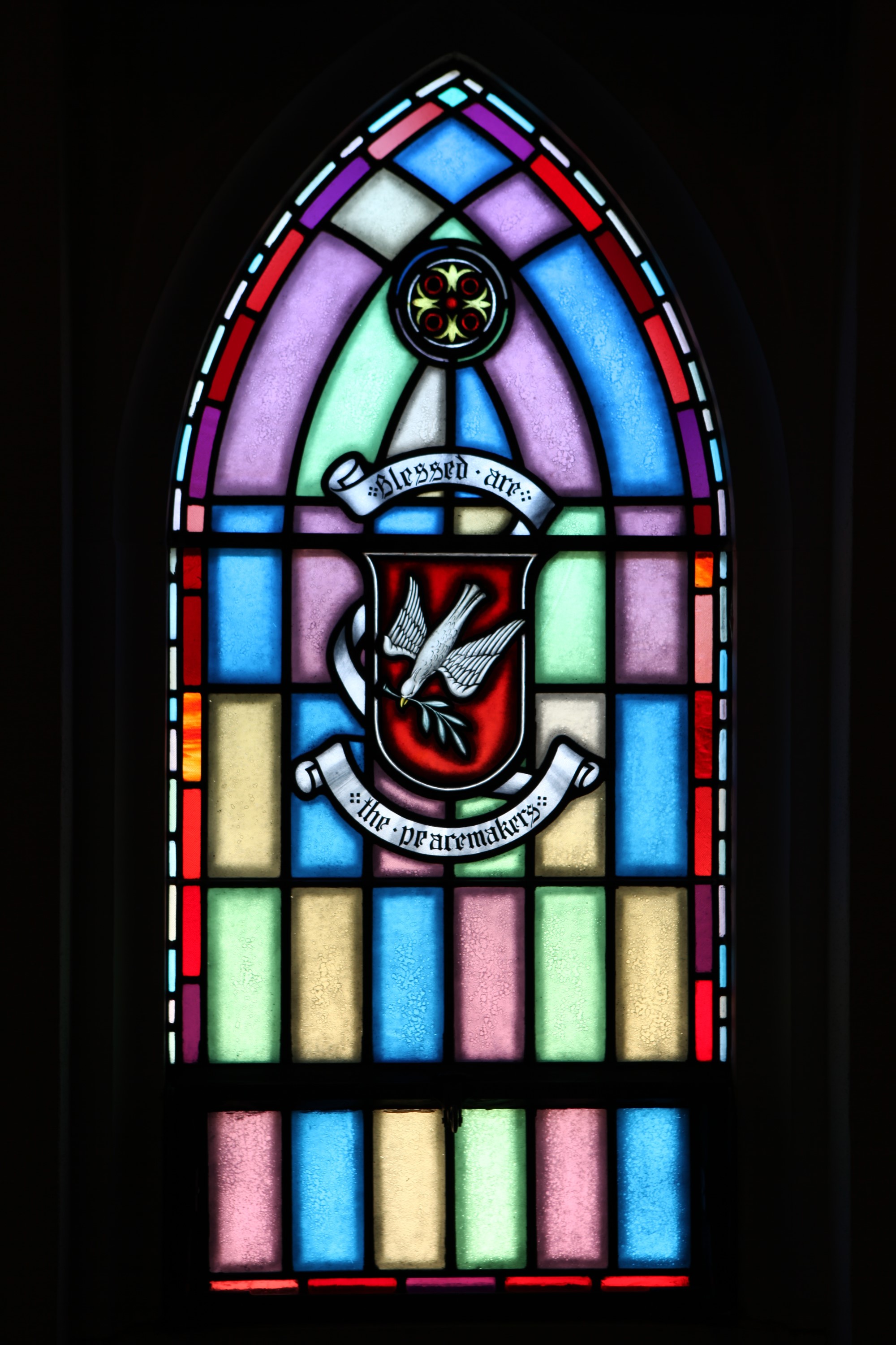 Stained glass window with dove design — protected by security glazing